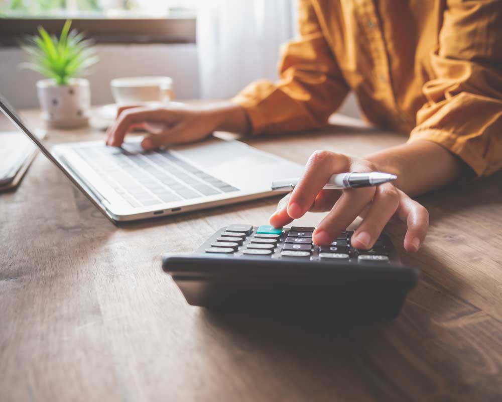 woman taking notes on laptop